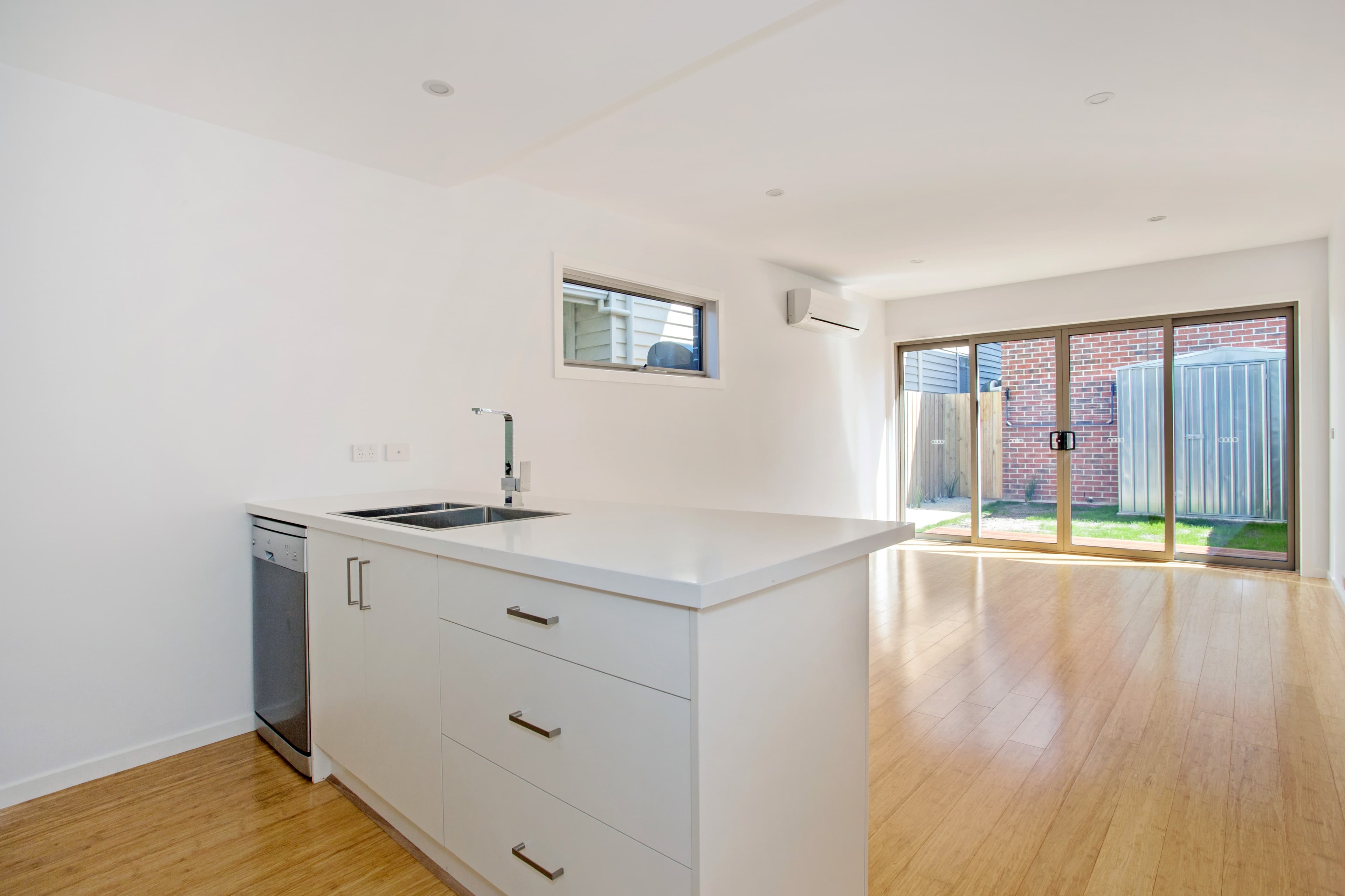 Chatham Street kitchen and living - island bench, bamboo floors and backyard outlook through sliding doors