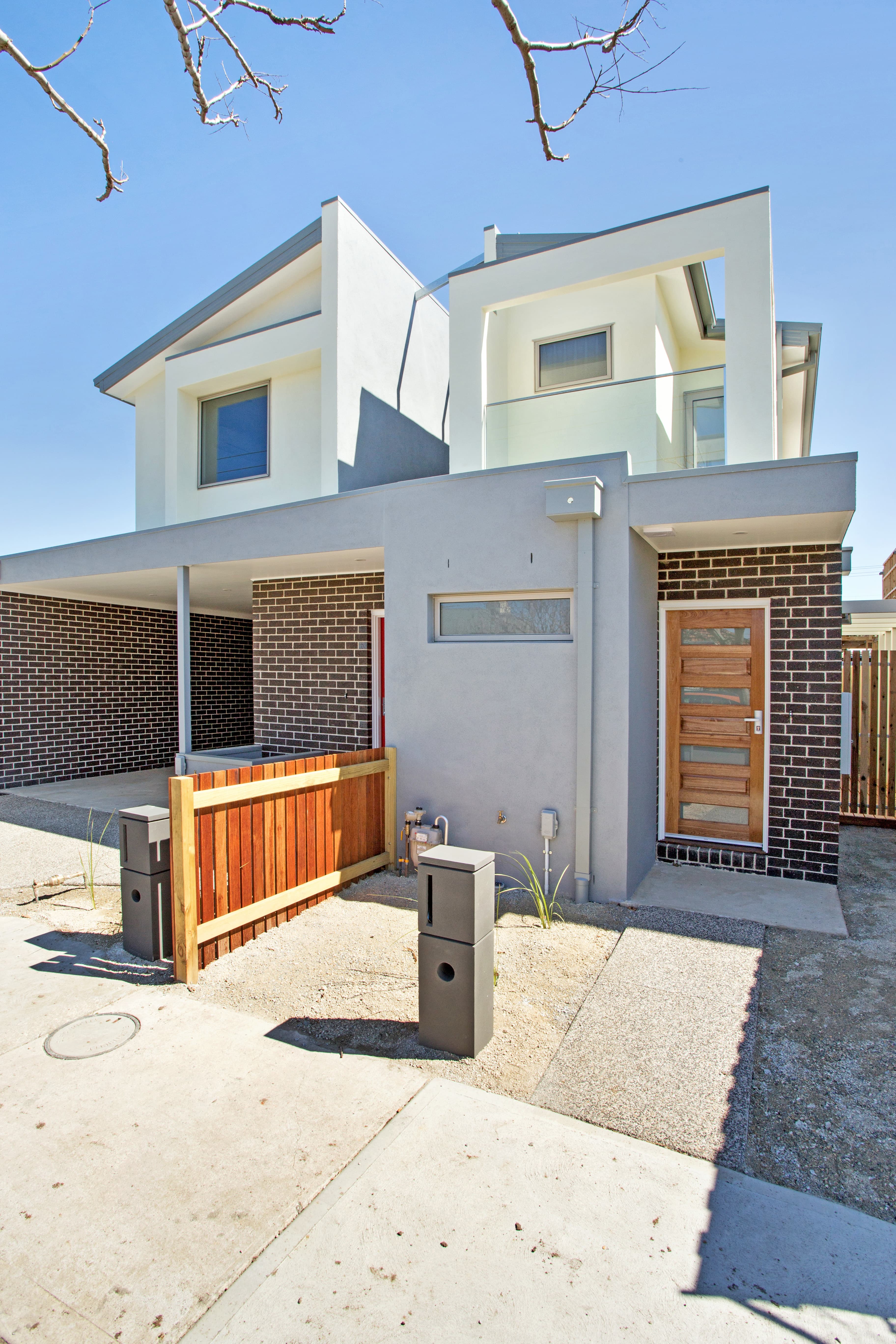 Chatham Street duplex exterior - two-storey rendered and brick build with timber gate and entrance door, Footscray VIC
