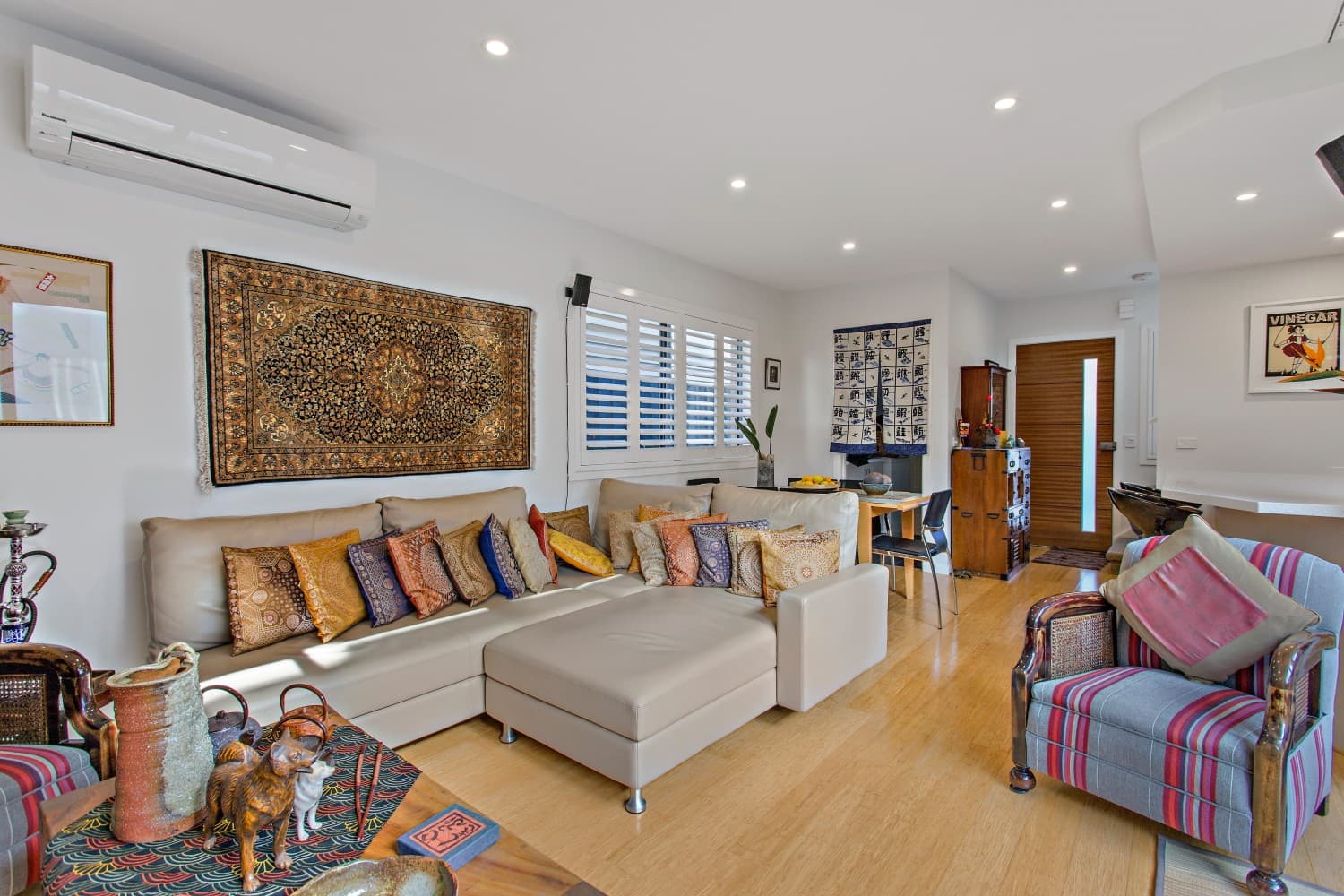 Macpherson Street living area with antique furniture and bamboo flooring